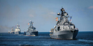 A fleet of military ships sailing in the ocean