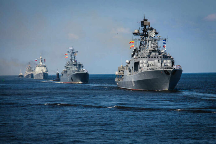 A fleet of military ships sailing in the ocean