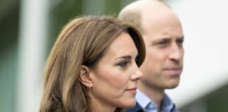 Profile view of a woman in a blue outfit and a man in a dark sweater