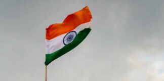 Indian flag waving against a cloudy sky