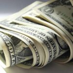 A close-up view of rolled one dollar bills