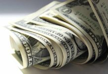 A close-up view of rolled one dollar bills