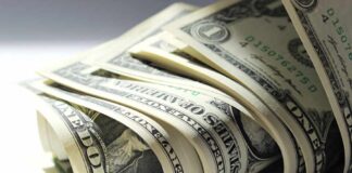 A close-up view of rolled one dollar bills