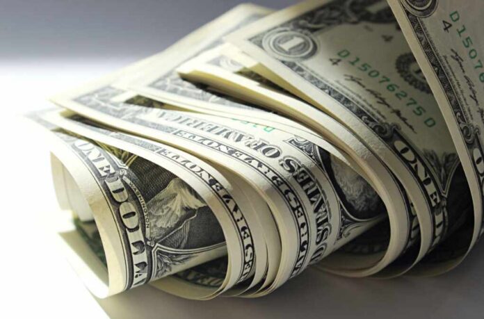 A close-up view of rolled one dollar bills