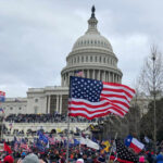 Millions March: Anti-Trump Fury Unleashed Crowd of protesters with American flags in front of the Capitol building