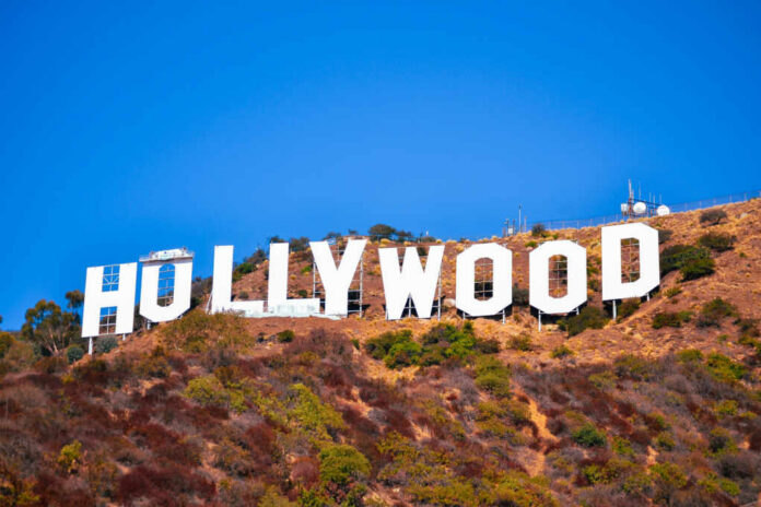 Hollywood sign on a hillside against a clear blue sky