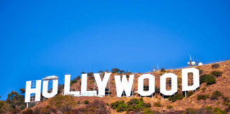 Hollywood sign on a hillside against a clear blue sky