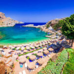 Hawaii Helicopter Horror: 3 Dead in Crash A picturesque beach with turquoise water and sun umbrellas