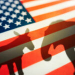 Shadows of a donkey and elephant on an American flag