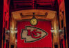 Large Kansas City Chiefs banner with a clock in a historic indoor setting