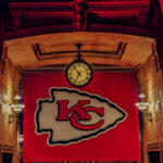 Large Kansas City Chiefs banner with a clock in a historic indoor setting