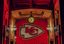 Large Kansas City Chiefs banner with a clock in a historic indoor setting