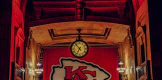 Large Kansas City Chiefs banner with a clock in a historic indoor setting