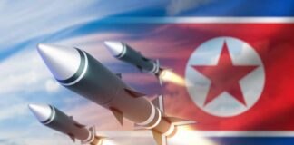 Three missiles launching against a backdrop of the North Korean flag
