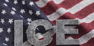 Letters 'ICE' placed on a background of an American flag