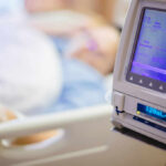 IV pump displaying medication flow rate in a hospital room