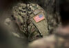 Close-up of a soldiers uniform featuring an American flag patch