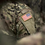 Close-up of a soldiers uniform featuring an American flag patch