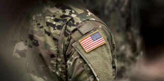 Close-up of a soldiers uniform featuring an American flag patch