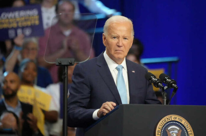 A man in a suit speaking at a podium during a public event