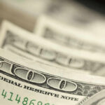 Shocking Economic Backlash Threatens GOP Close-up of several one hundred dollar bills stacked together