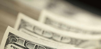 Close-up of several one hundred dollar bills stacked together