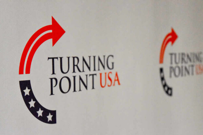 Logo of Turning Point USA displayed on a backdrop