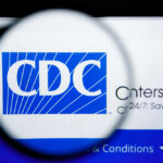 Magnifying glass focusing on the CDC logo on a computer screen