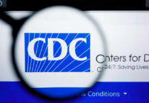 Magnifying glass focusing on the CDC logo on a computer screen