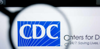Magnifying glass focusing on the CDC logo on a computer screen