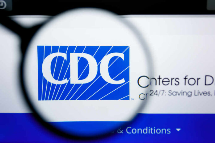 Magnifying glass focusing on the CDC logo on a computer screen