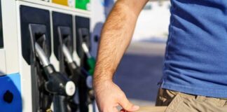 Person at a gas station showing empty pockets