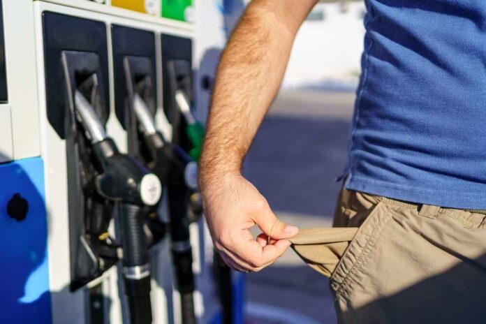 Person at a gas station showing empty pockets