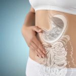 Illustration of a woman's digestive system with a focus on the stomach