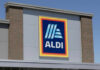 ALDI grocery store sign against a clear blue sky