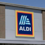ALDI grocery store sign against a clear blue sky