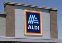 ALDI grocery store sign against a clear blue sky
