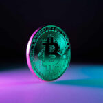 A shiny Bitcoin coin illuminated with colorful lighting against a dark background