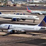 Three commercial airplanes on an airport runway