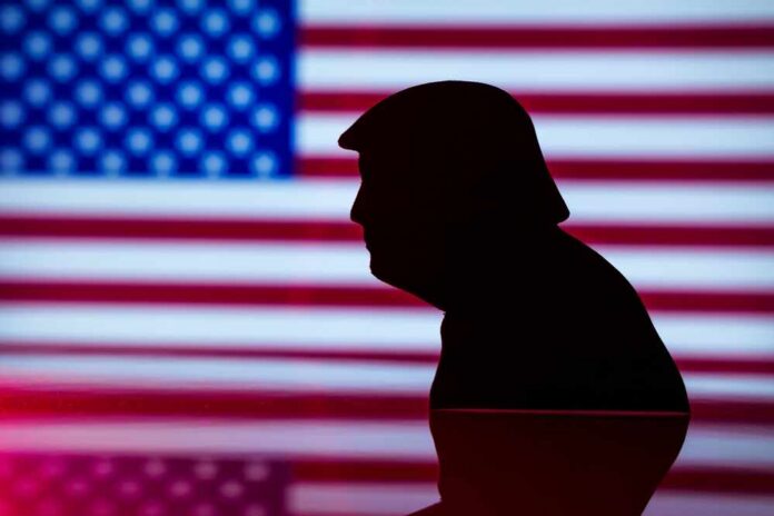 Silhouette of a person against an American flag background