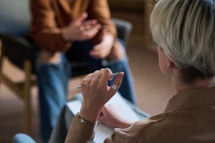 Two individuals engaged in a conversation during a counseling session