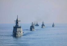 A fleet of military ships sailing in the ocean