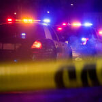 Texas Dad’s Deadly Defense: Carjacker Shot Police cars with flashing lights at a nighttime scene behind crime scene tape