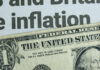 Sudden Inflation Surge Shocks US Families Close-up of a US dollar bill with a newspaper headline about inflation