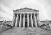 Racial Redistricting Battle: Courts vs. Supreme Court Front view of the Supreme Court building with columns and statues