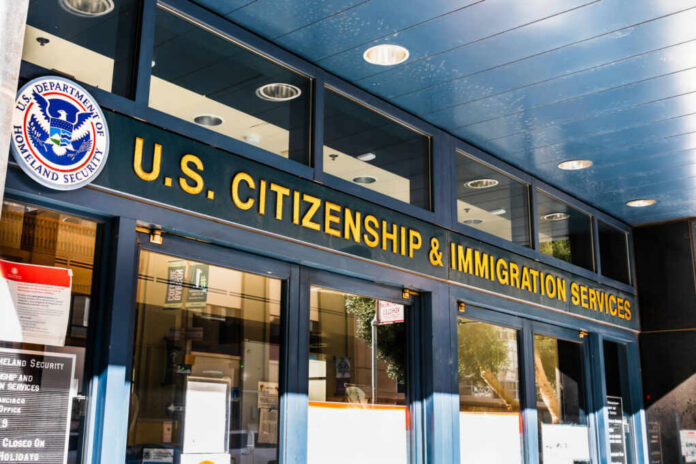 shutterstock_1569360250 Entrance of the U.S. Citizenship and Immigration Services office with signage