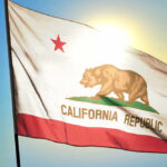 Gubernatorial Frontrunner Caught in Staff Abuse Scandal California state flag waving in the sunlight