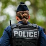 Prosecutor DROPS Charges: Officer Walks Free Back view of a police officer wearing a uniform and a police vest