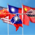Hands painted with flags of China and the USA pulling a torn Taiwan flag
