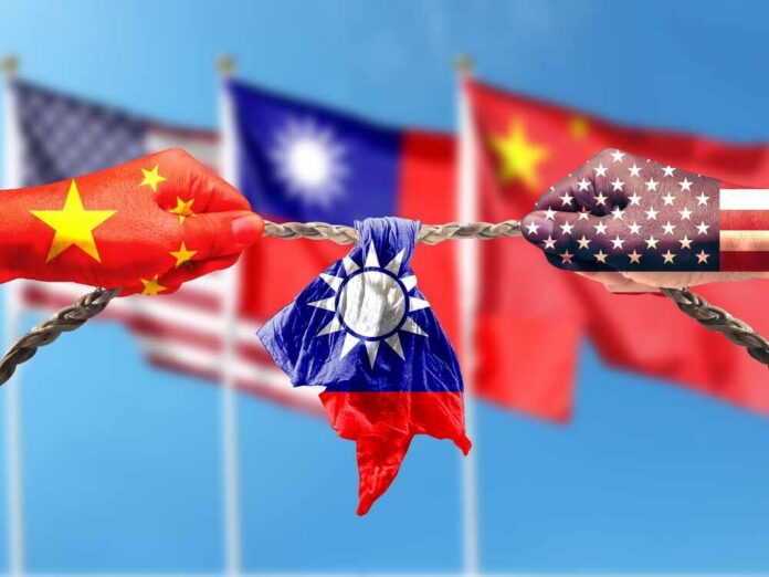 Hands painted with flags of China and the USA pulling a torn Taiwan flag